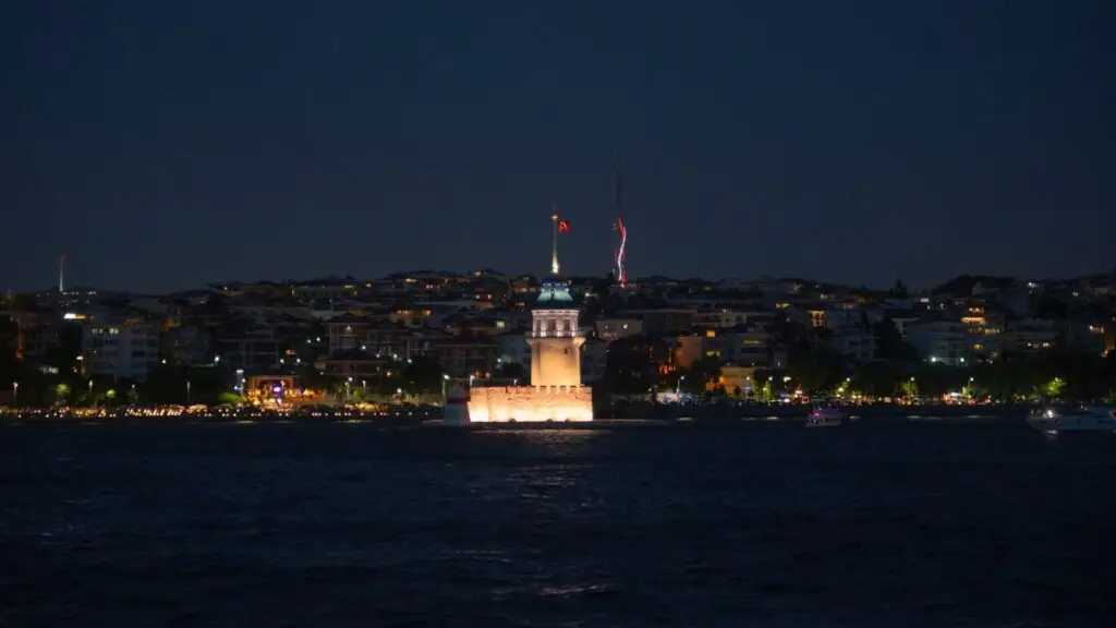 Maiden's tower illuminated at night over water