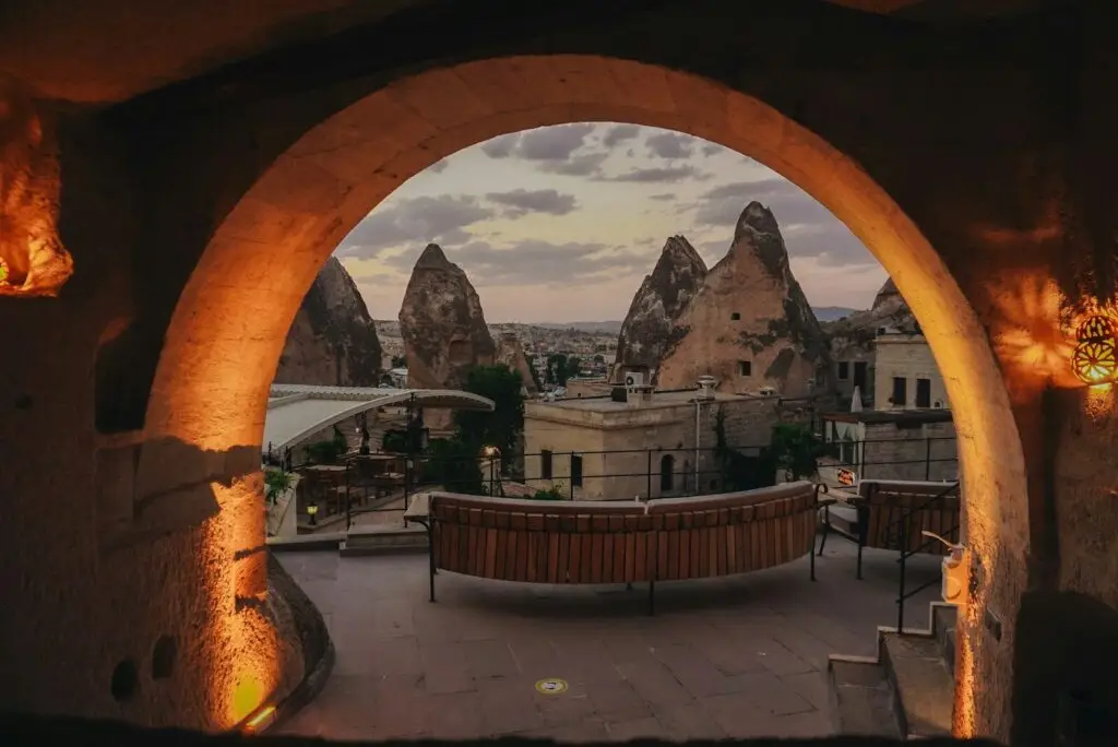 Fairy chimneys and buildings viewed through an archway.