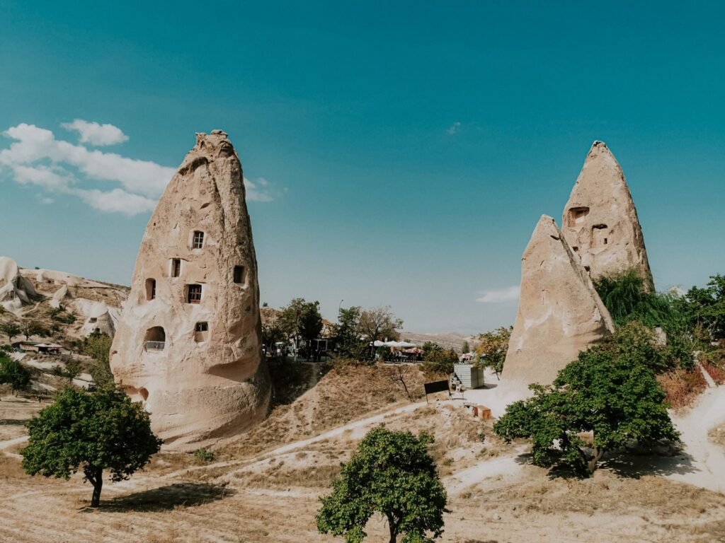 Explore the unique fairy chimneys in Cappadocia, Turkey, featuring stunning geological formations.