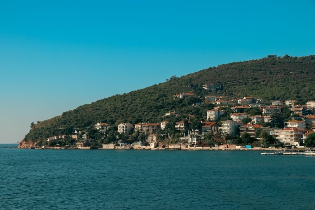 Beautiful summer view of the Istanbul Princely Islands coast, showcasing the serene seashore and hillside architecture.