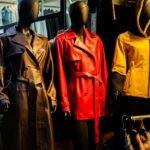 Colorful leather coats on mannequins in a stylish window display.