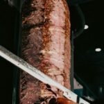 Juicy döner kebab being sliced, showcasing authentic Turkish street food in İzmir.