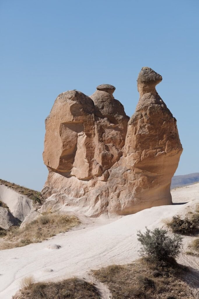a large rock formation in the middle of a desert
