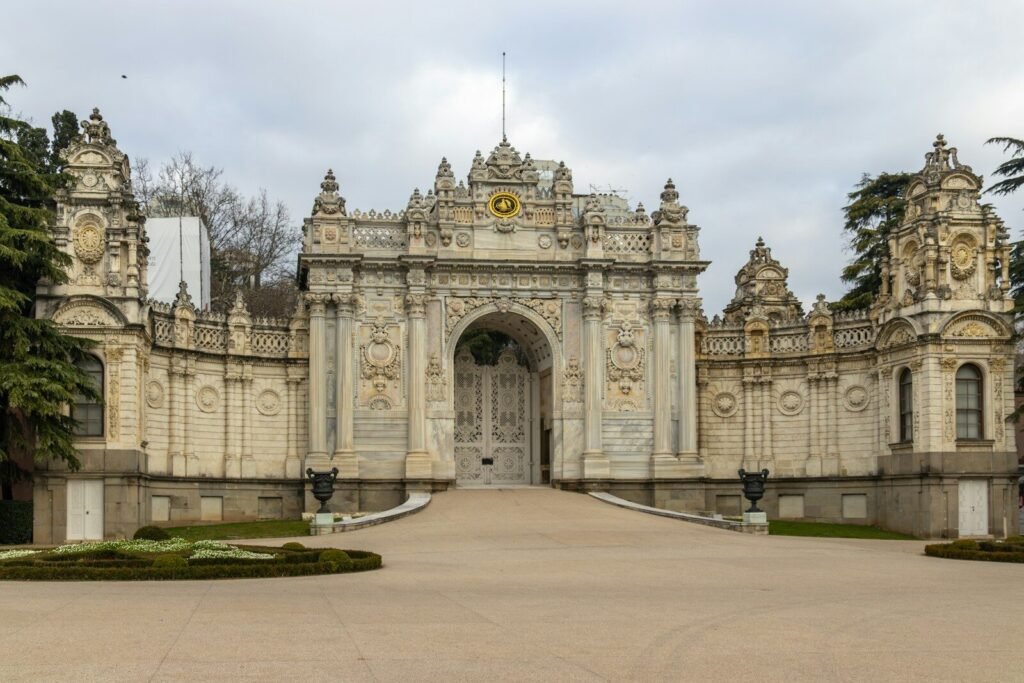 A large stone building with a gate and a clock tower