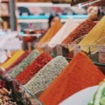 assorted color powder on brown wooden shelf